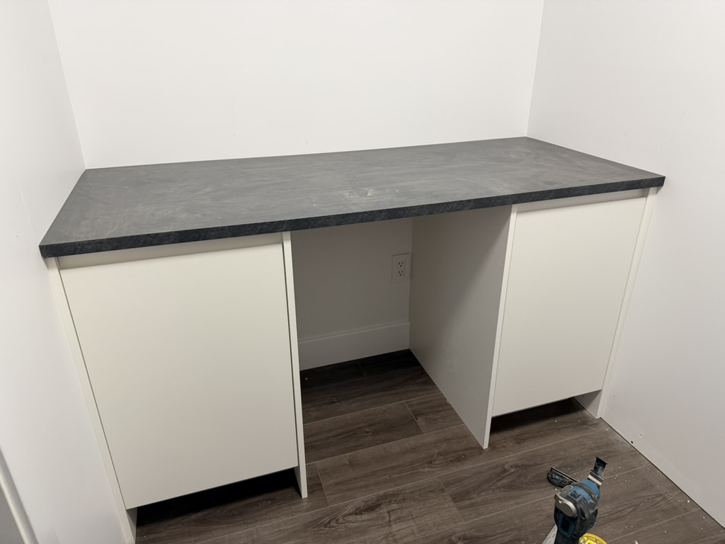 Walk-in closet with custom cabinets and shelving.