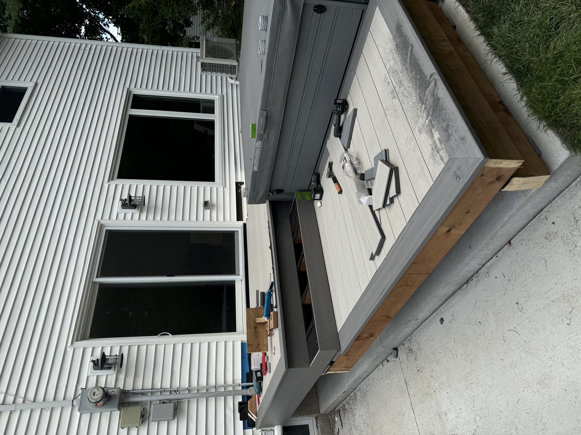 Spacious backyard deck with composite decking - During