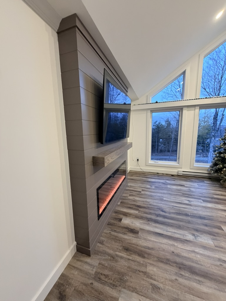 Electric fireplace mantel with TV.